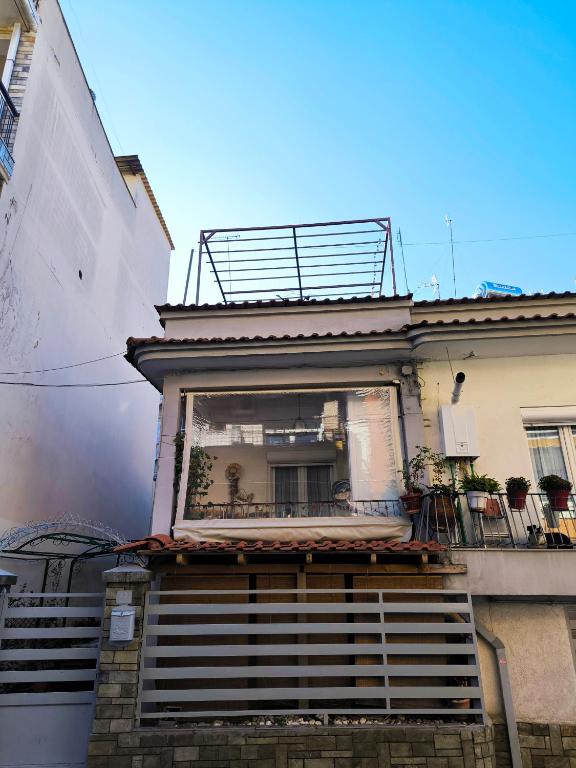 a building with a balcony with plants on it at Kimon Penthouse in Thessaloniki