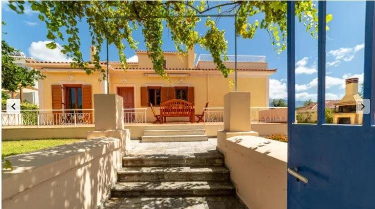 a house with a blue door in front of it at Villa Katerina BBQ & pool! in Metaxáta