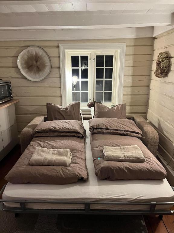 two beds sitting on top of a bed in a room at Sentrum Lillesand unique accommodation in Lillesand