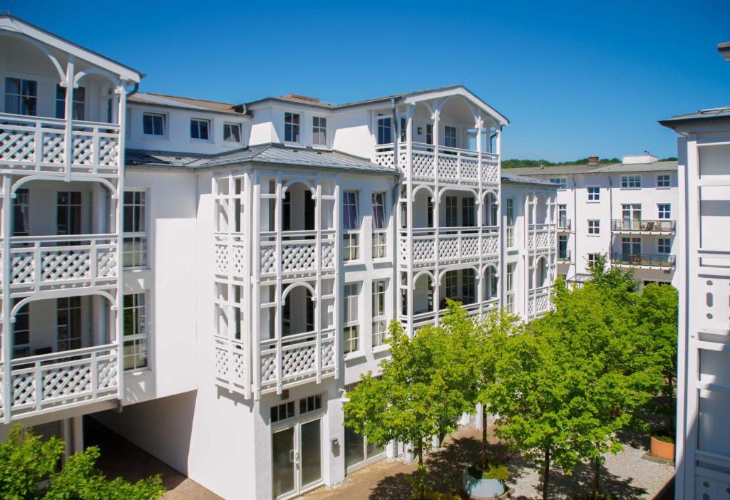 a row of white apartment buildings with white balconies at Ferienappartement im Seepark Sellin in Ostseebad Sellin