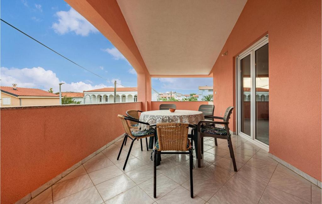 a patio with a table and chairs on a balcony at Two-Bedroom Apartment In Vir in Vir