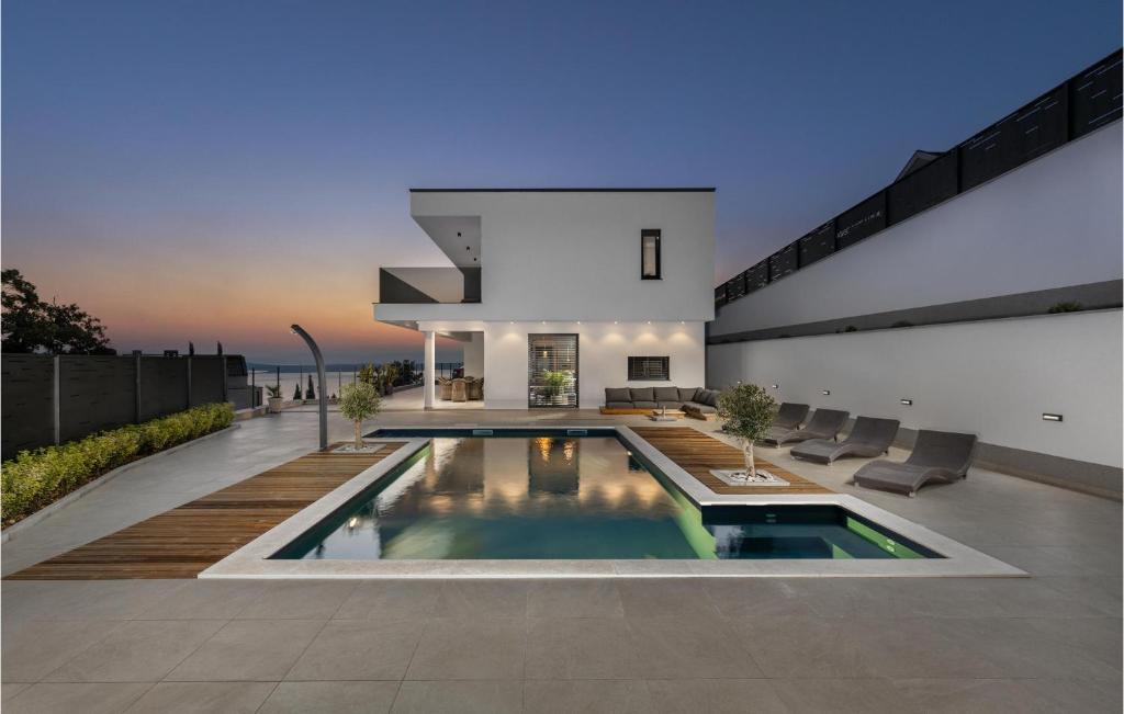 a house with a swimming pool in the backyard at Stunning Home In Crikvenica in Crikvenica