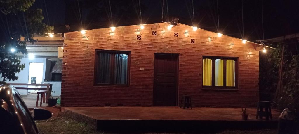a brick house with lights on it at night at Casona el ancla in Eldorado