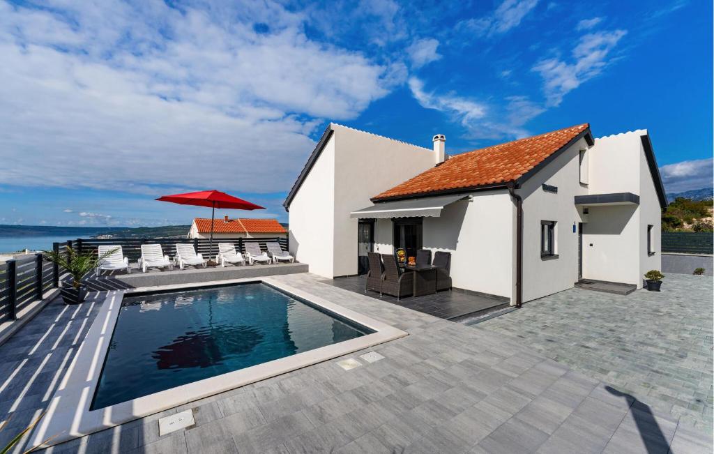 a villa with a swimming pool and a house at Stunning Home In Maslenica With Wifi in Maslenica