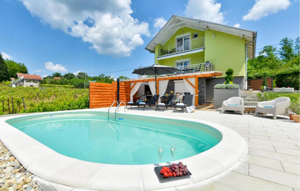 a swimming pool in front of a house at Nice Home In Popovaca With Sauna in Popovača