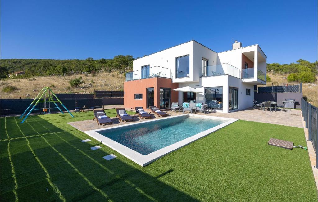 a house with a swimming pool and a playground at Luxurious Home In Dicmo in Dicmo