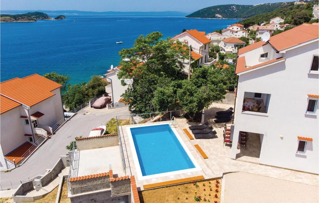 a villa with a swimming pool and a view of the ocean at Pet Friendly Home In Supertarska Draga in Supetarska Draga