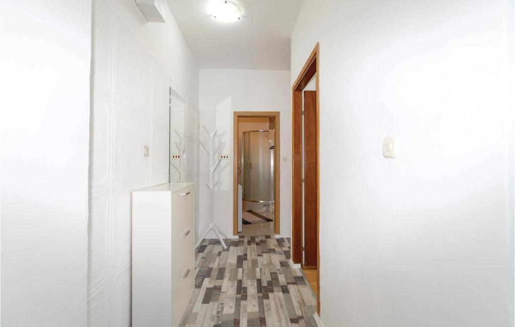 a hallway with white walls and a white refrigerator at Awesome Apartment In Zadar With Wifi in Zadar