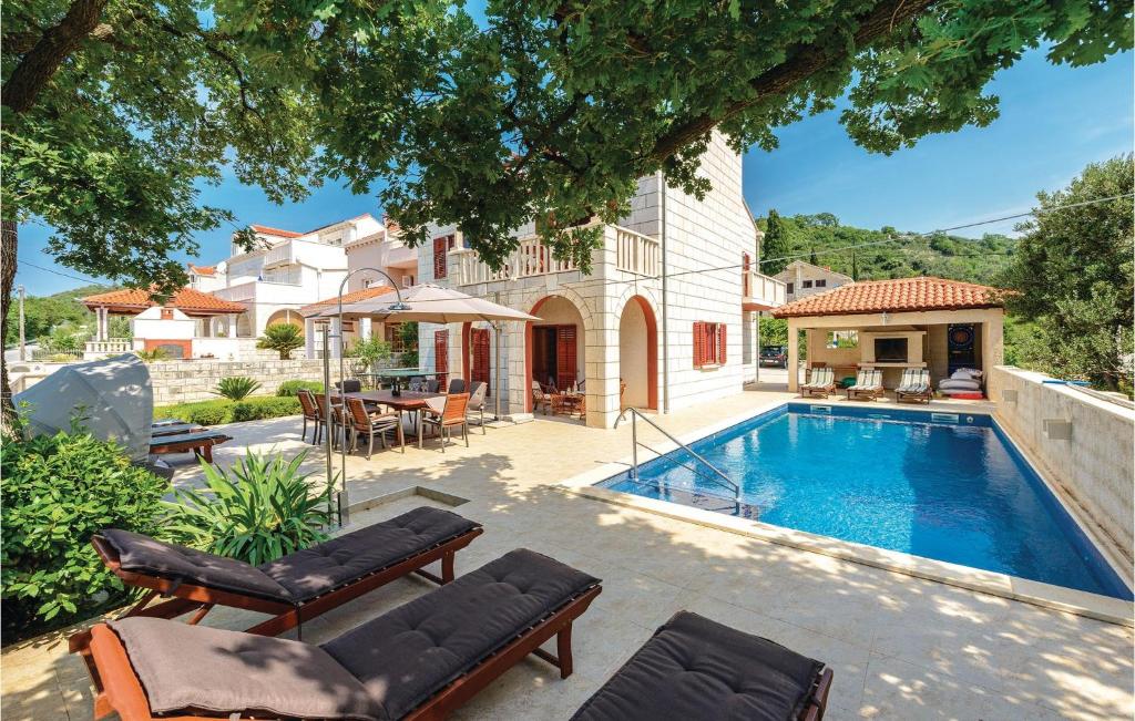 a home with a swimming pool and a house at Holiday Home Pinji Vi in Zaton