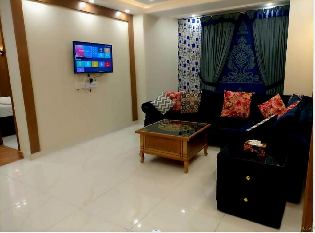 a living room with a couch and a coffee table at Royal Galaxy Hotel & Residence - Near Islamabad International Airport & Motorway in Islamabad