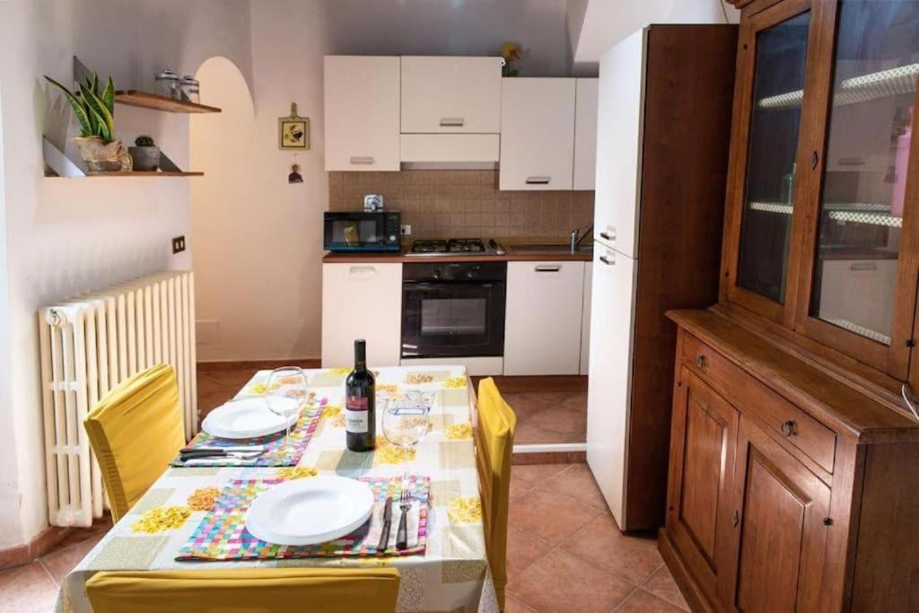 a kitchen with a table with a bottle of wine at Il nido d amore Florence wi-fi conditioned air in Florence
