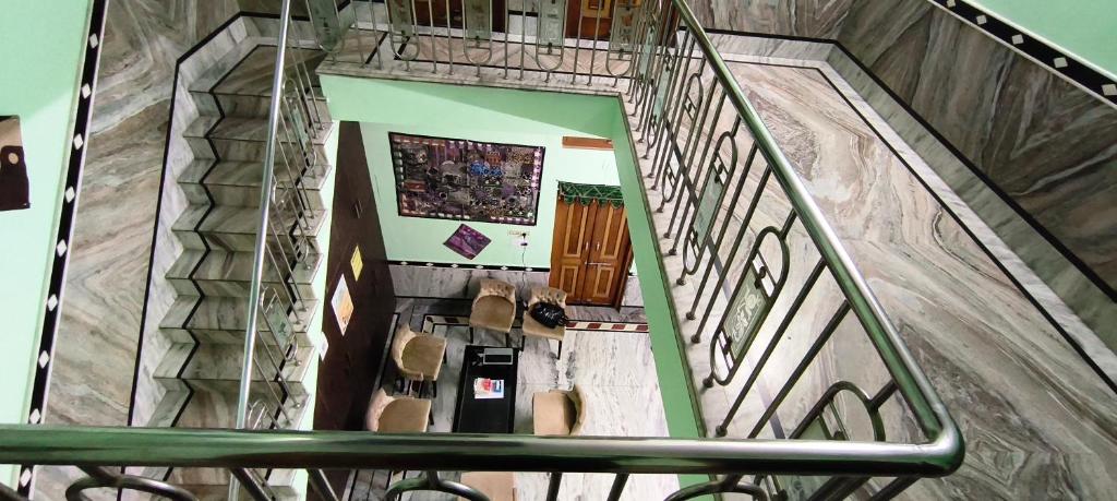 an overhead view of a spiral staircase with a stair railing at Rose Merry Guesthouse in Bikaner