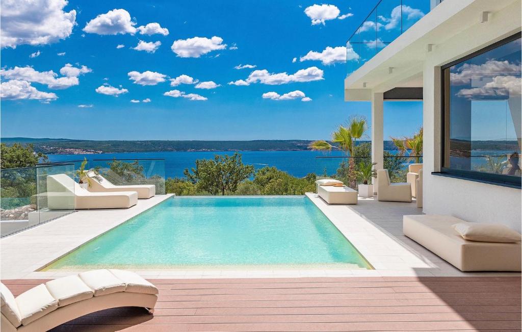 a swimming pool in a villa with a view of the ocean at Villa Michelle in Maslenica
