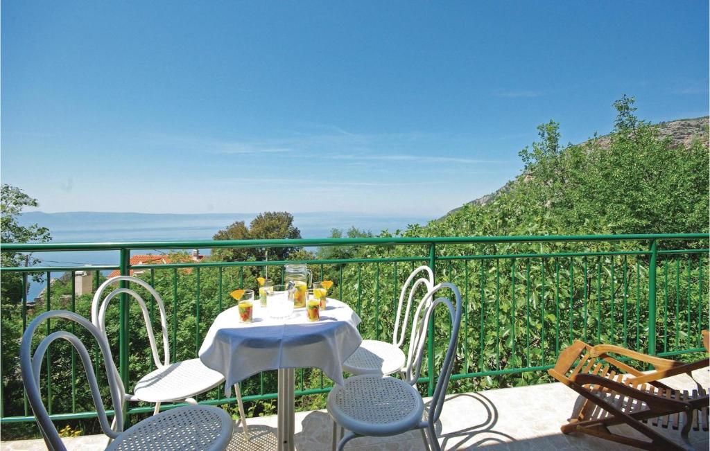a table and chairs on a balcony with a view at Holiday Home Gornje Tucepi With Fireplace Vii in Tučepi