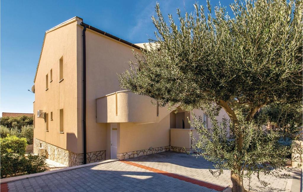budynek z drzewem przed nim w obiekcie Cozy Apartment In Mandre With Wifi w mieście Mandre