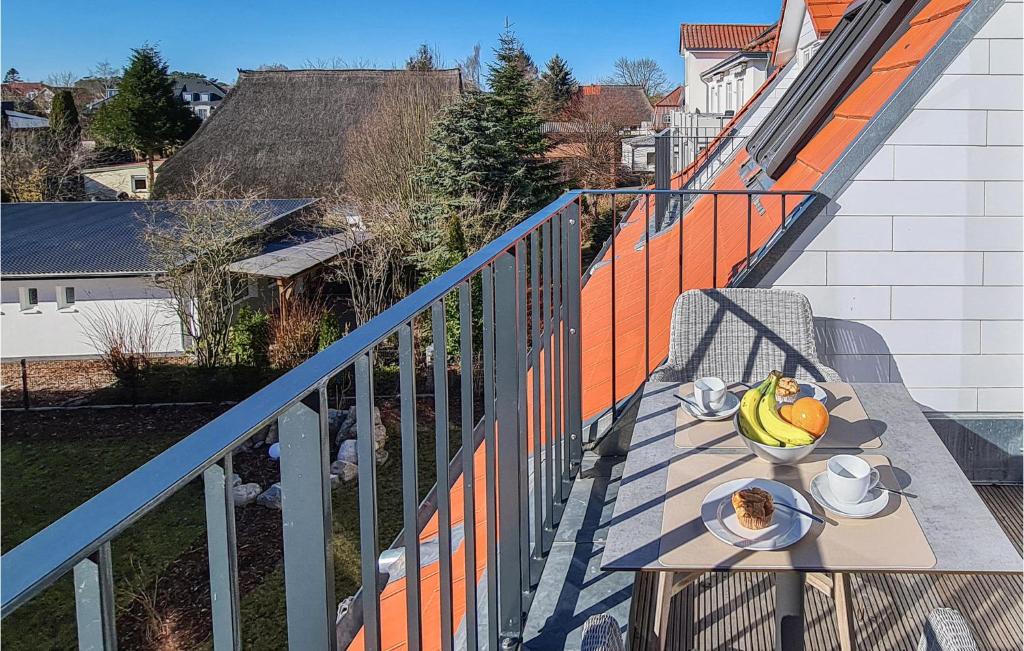 a table with a bowl of fruit on a balcony at Baltischer Hof Apartment 57 in Boltenhagen