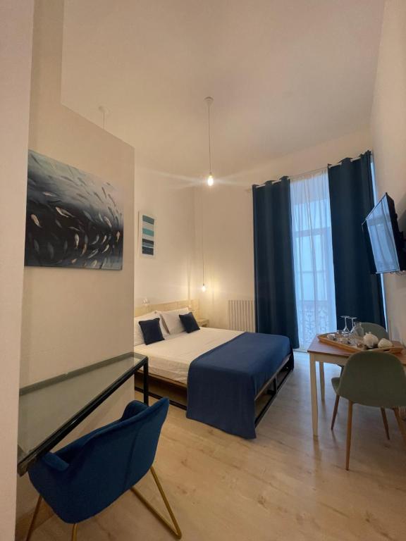 Postel nebo postele na pokoji v ubytování D'Angiò Rooms-Manfredi Homes&Villas