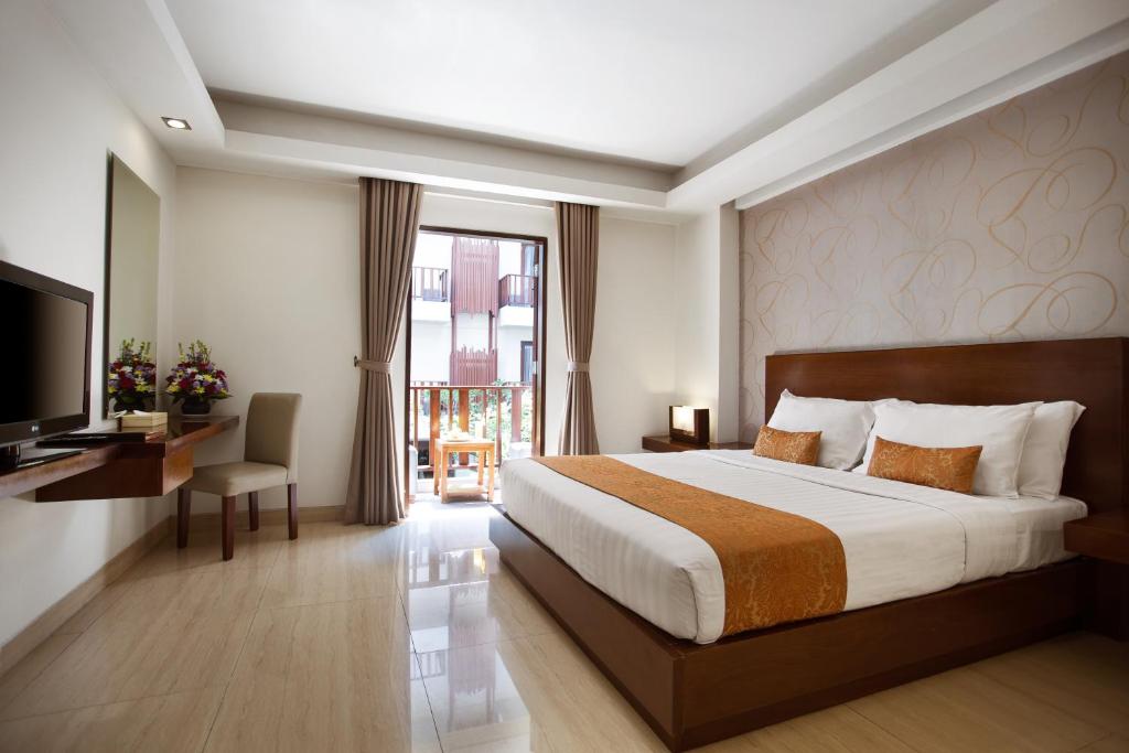 Postel nebo postele na pokoji v ubytování d'primahotel Seminyak
