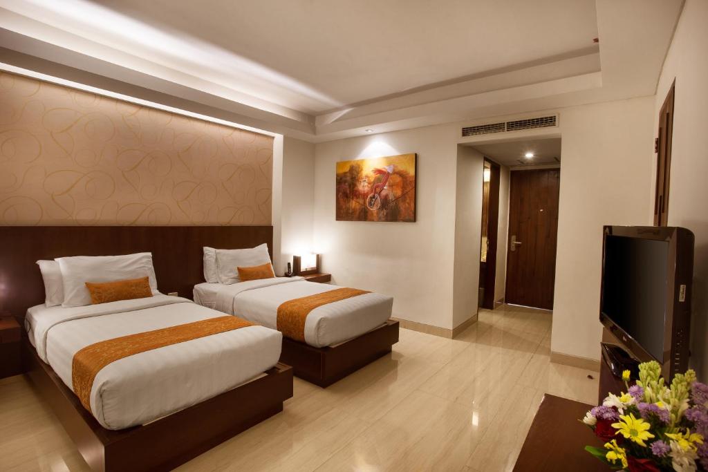Postel nebo postele na pokoji v ubytování d'primahotel Seminyak