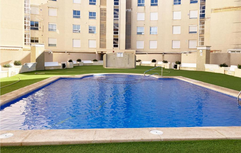 a large swimming pool in front of a building at Nice Apartment In El Campello With Wifi in El Campello