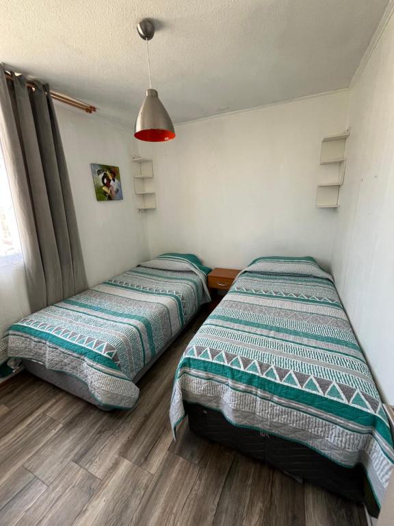 En eller flere senge i et værelse på Arriendo hermoso departamento la serena