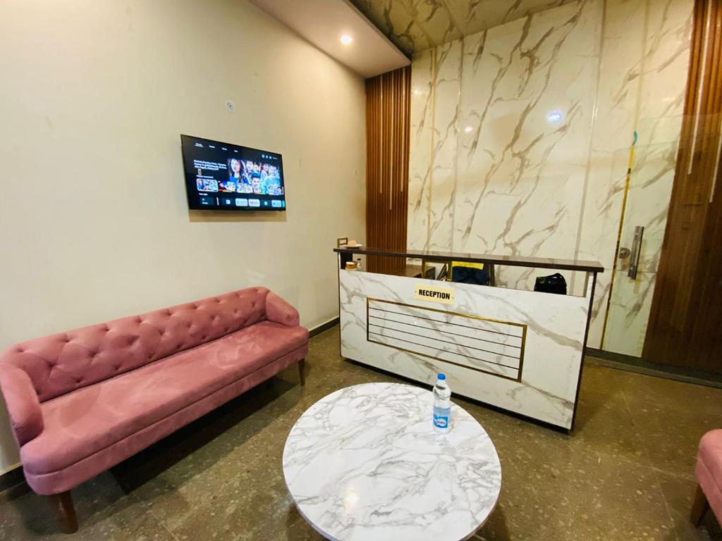 a living room with a couch and a table at RY Luxuries, 300m from Golden Temple in Amritsar