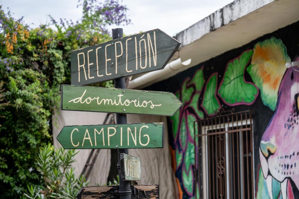 un cartello stradale di fronte a un edificio con graffiti di Ekko Hostel a Tepoztlán