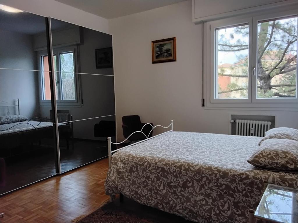 a bedroom with a bed and a window at Appartamento Stadio free bike in Bologna