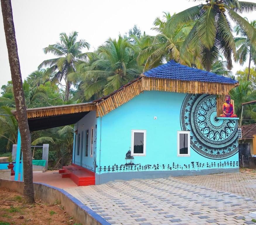 a blue house with a large clock on it at Blue Eye Coastal House, Beach House in Kaup
