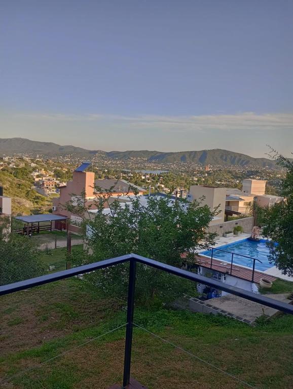 a view of a swimming pool and a city at vistas del valle in Villa Carlos Paz