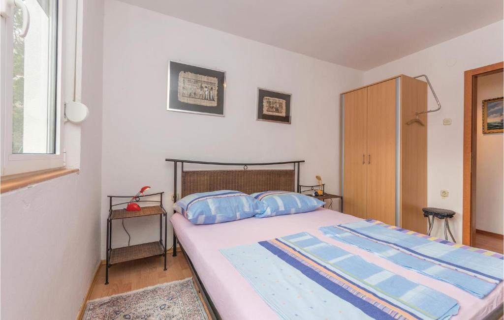 Postel nebo postele na pokoji v ubytování Apartment Donji Karin 11
