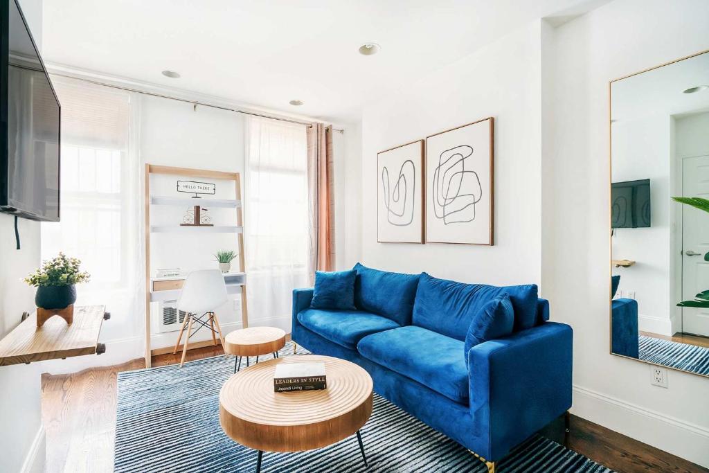 a living room with a blue couch and a table at 69-3B Celebrate in Style 1BR Prime Lower East Side Brand New in New York
