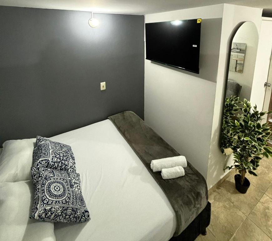 a bedroom with a large bed with a mirror at Apartamentos Bello Antioquia in Bello