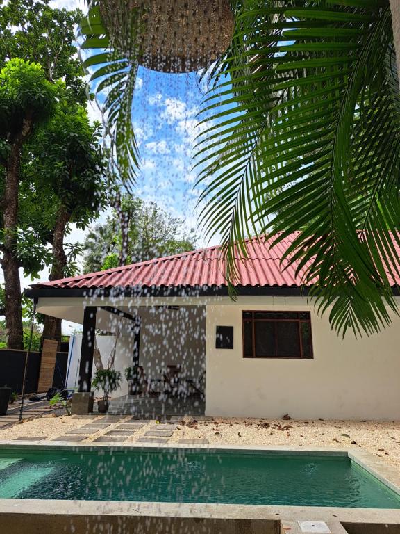 a house with a red roof and a swimming pool at Zoa Villas - Santa Teresa - 2 min walk to beach in Santa Teresa Beach