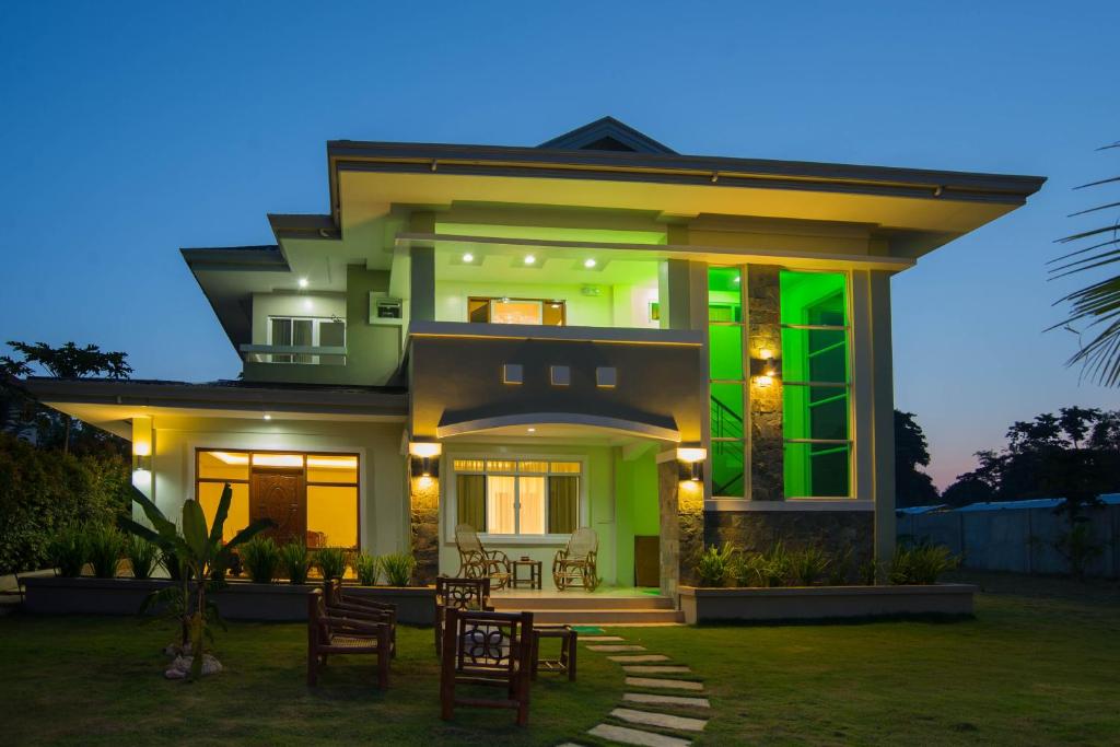 a house with a green hue at night at Oasi Fiore Bed & Breakfast in Panglao Island