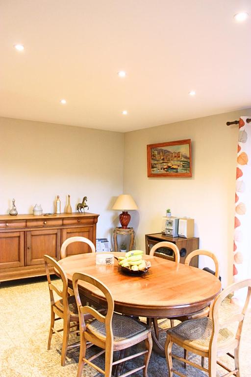 une salle à manger avec une table et des chaises en bois dans l'établissement Maison de campagne mer et montagne, à Sorbo-Ocagnano
