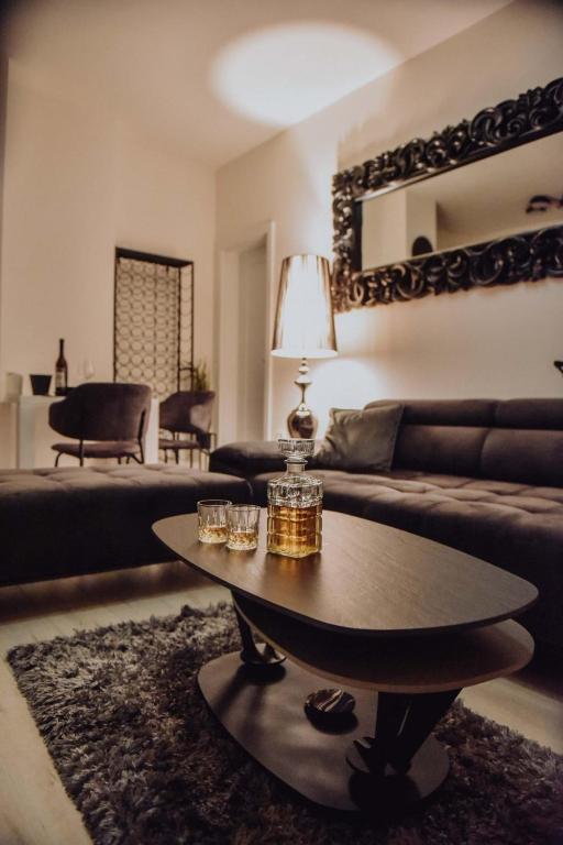 a living room with a couch and a coffee table at Lux Grey in Đakovo