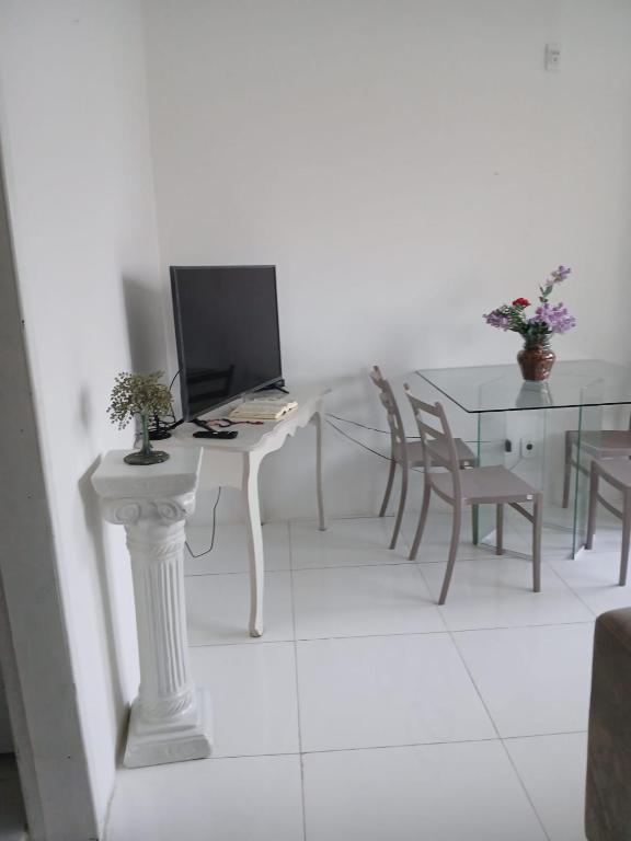 a room with a table with a computer on it at casa OLINDA in Salvador
