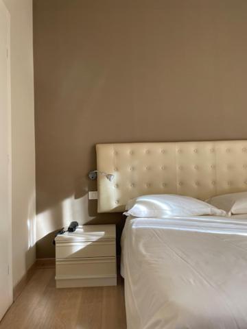 Rúm í herbergi á Albergo Commercio - Ristorante Mas-cì