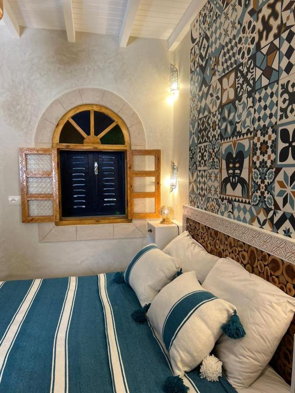 Postel nebo postele na pokoji v ubytování Riad dar Hania