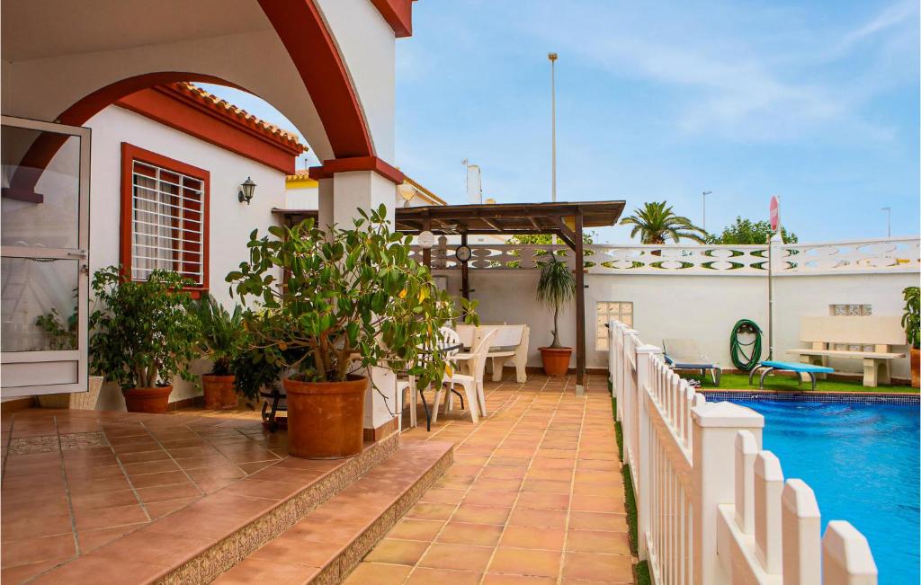 a house with a swimming pool and a patio at Gorgeous Home In Pilar De La Horadada in Pilar de la Horadada