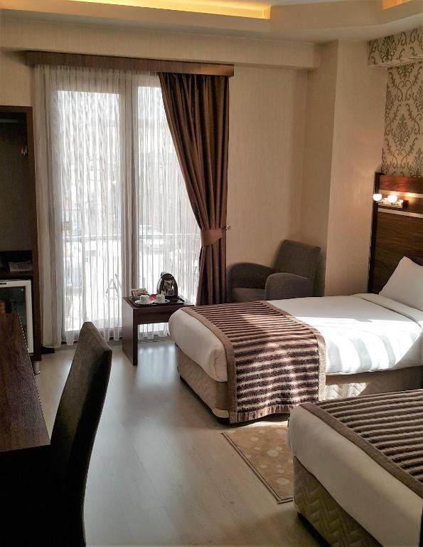 A bed or beds in a room at My Liva Hotel