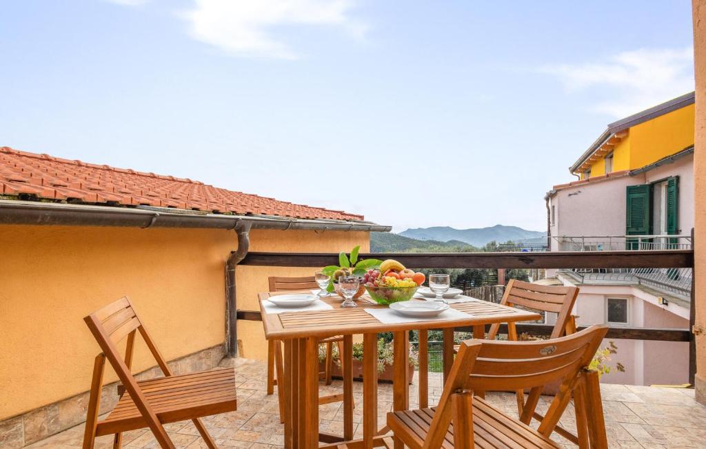 a table with chairs and a bowl of fruit on a balcony at 1 Bedroom Amazing Home In Onzo in Onzo