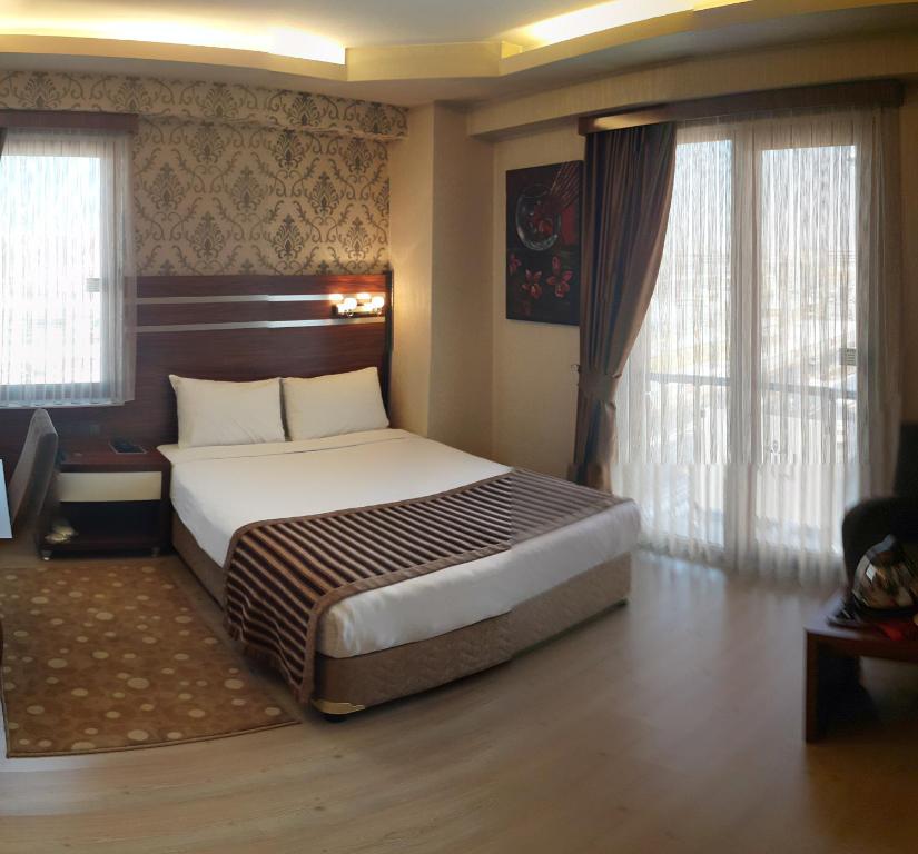 Un pat sau paturi într-o cameră la My Liva Hotel