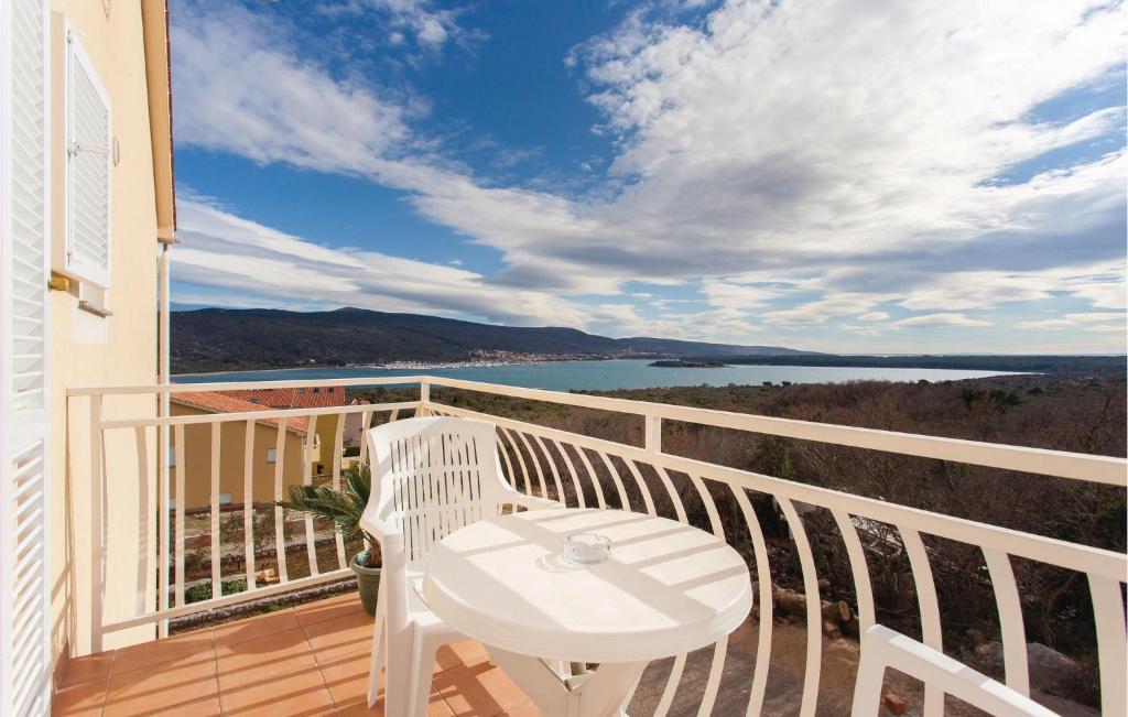 a balcony with a table and a view of the water at Lovely Apartment In Kornic With Wifi in Kornić