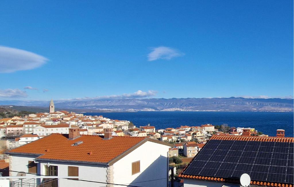 a view of a city with solar panels on the roofs at 1 Bedroom Beautiful Apartment In Vrbnik in Vrbnik