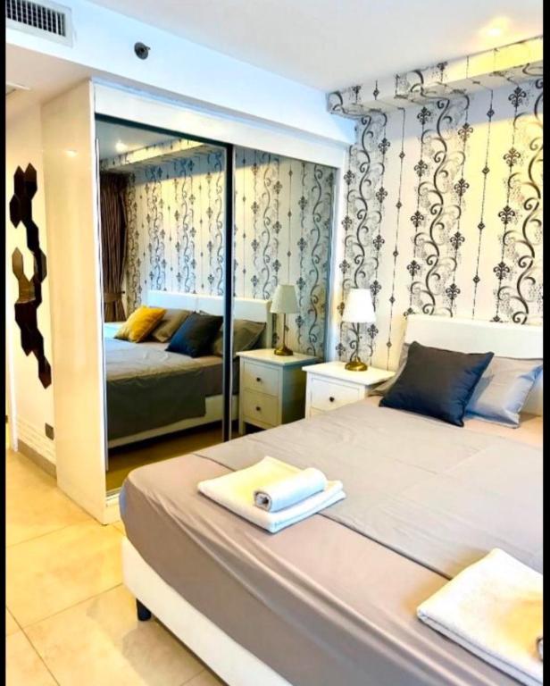 Postel nebo postele na pokoji v ubytování Centara Pattaya Apartment