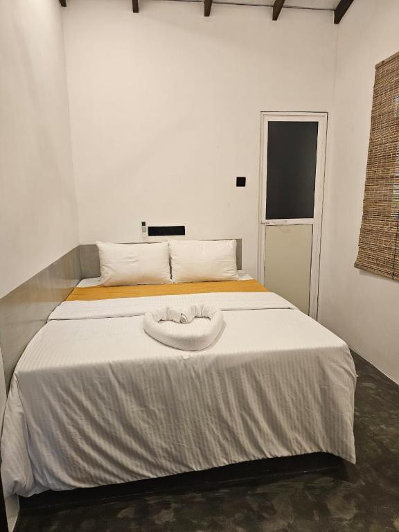 Postel nebo postele na pokoji v ubytování Muthu Hiriketiya