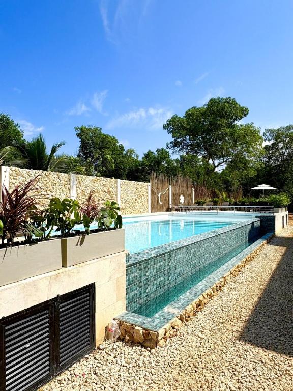 a swimming pool in front of a building at Apartment in Coveñas FOREST in Coveñas