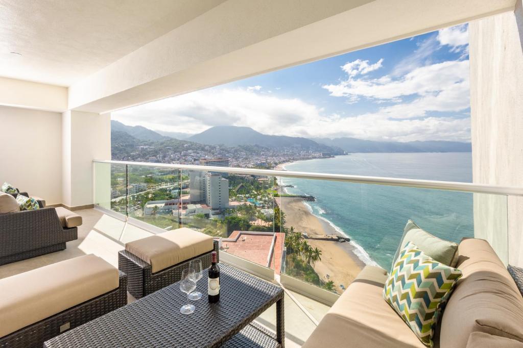 a living room with a view of the ocean at Wake Up to Paradise – Stunning 2BR Condo Right on the Beach in Puerto Vallarta